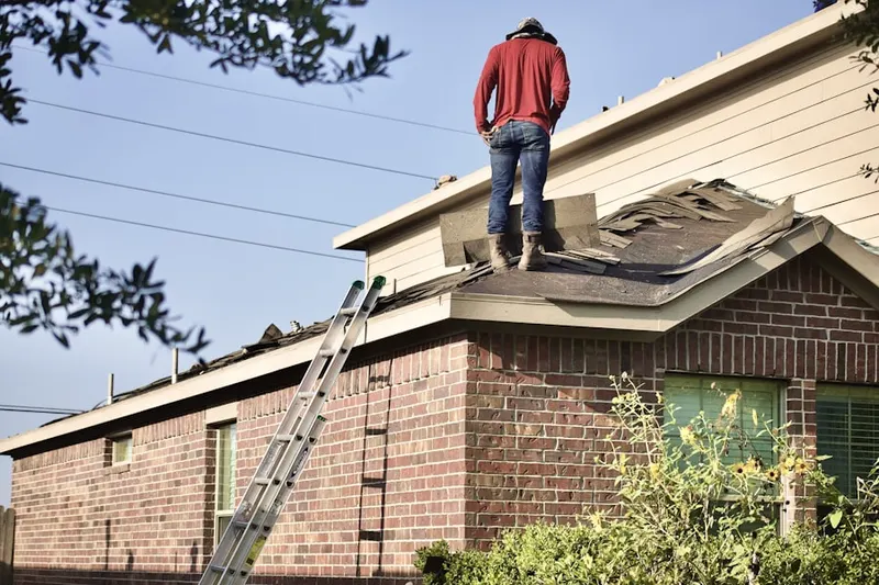 Professional roofer working on a residential roof in Burnet